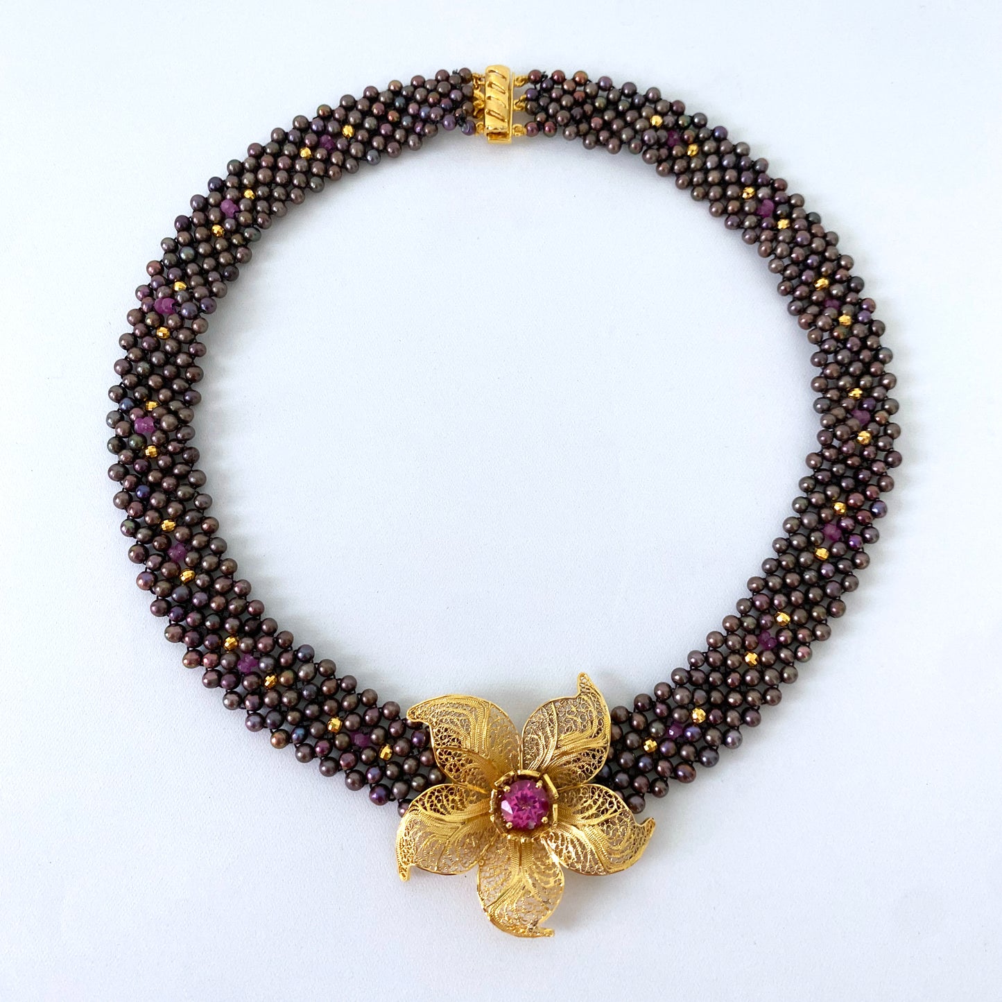 Woven Black Pearl Necklace with Pink Topaz & Golden Floral Centerpiece