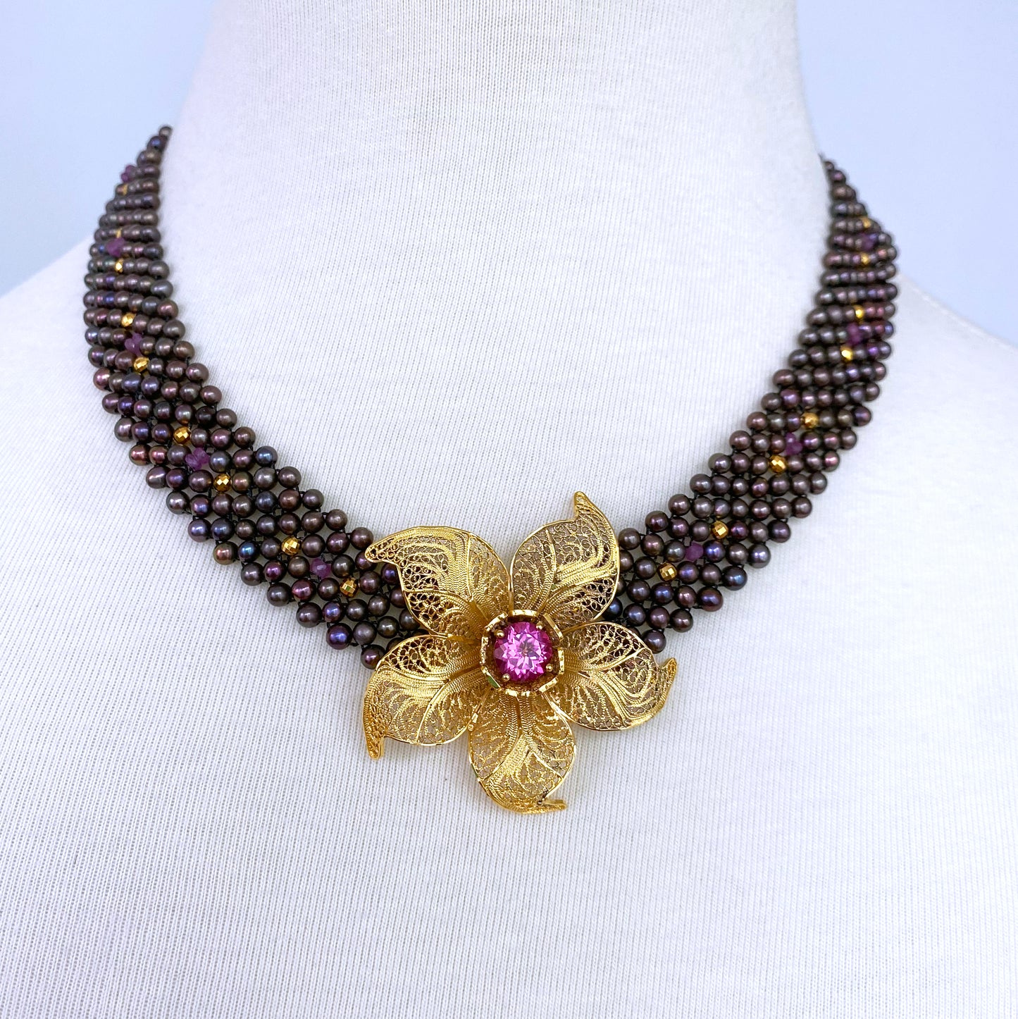 Woven Black Pearl Necklace with Pink Topaz & Golden Floral Centerpiece